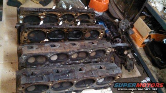 Stack of four used engine cylinder heads
