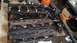 1977 Ford F-150 - Four engine cylinder heads are stacked and appear to be used or in need of rebuilding.