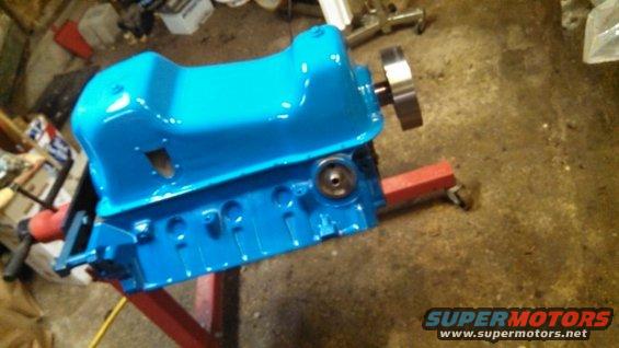 Blue engine block on a red stand