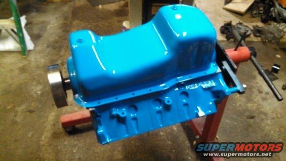 Blue painted engine oil pan on a stand