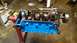 1977 Ford F-150 - A Ford V8 engine block, painted blue, is shown on an engine stand with its internal components visible.
