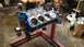 1977 Ford F-150 - Engine block on a stand in a workshop setting.