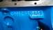 1977 Ford F-150 - Close-up of a blue engine block showing casting numbers D4AE-6015-AA5 and other markings.