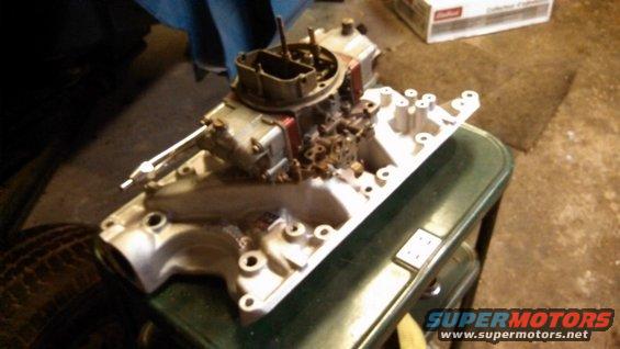 Engine intake manifold and carburetor assembly on a table
