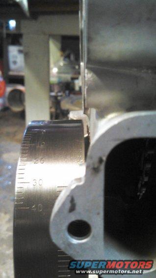 Engine part with a metal scale showing measurements up to 40