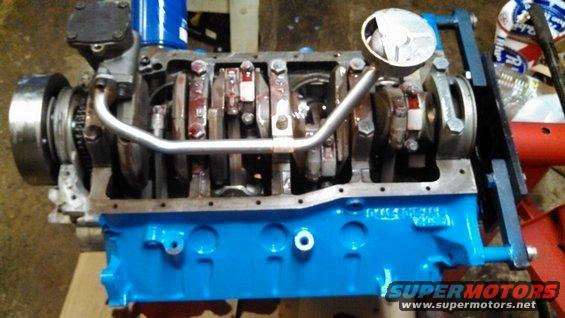 Engine block painted blue, showing crankshaft and connecting rods