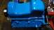 1977 Ford F-150 - A blue painted engine block is shown with a metal pulley attached to the crankshaft end.
