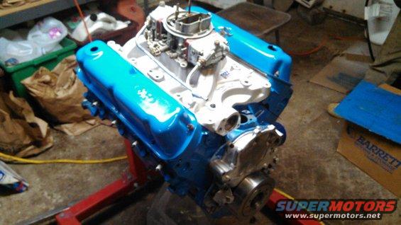 Blue valve covers on a V8 engine on a stand