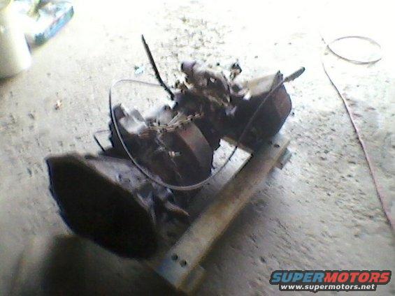 Transmission and engine components on a wooden stand