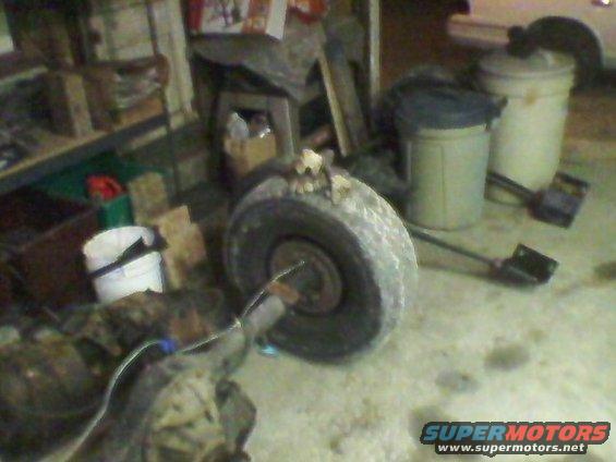 Spare tire and differential on a workshop floor