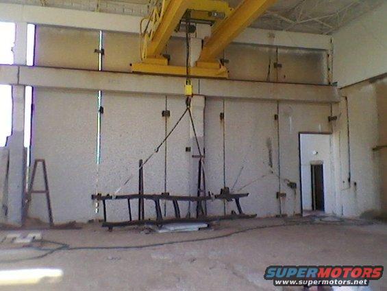 Industrial interior with overhead crane and suspended load