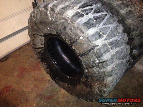 Stack of large off-road tires with aggressive tread