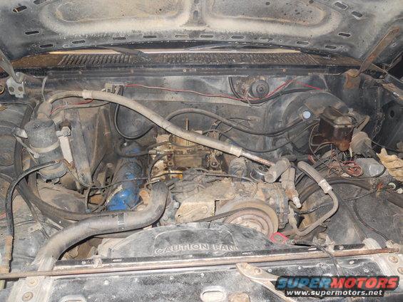 1980 Ford Bronco engine bay with V8 engine, carburetor, and fan shroud