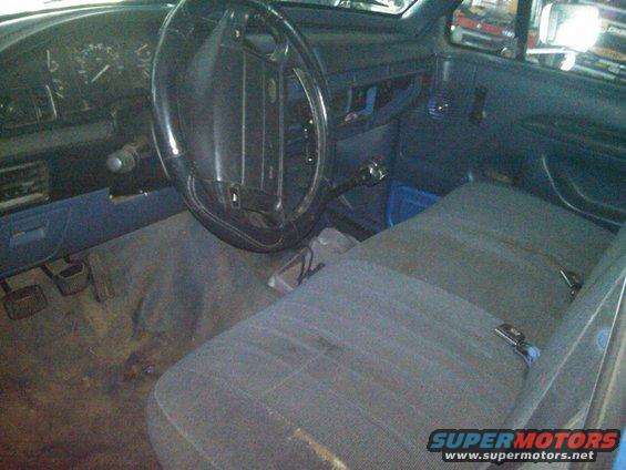 1993 Ford Bronco interior with blue seats and dashboard