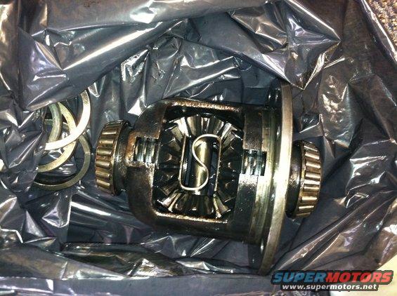 Differential gears and bearings inside black plastic packaging