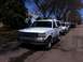 1994 Ford Bronco - A white 1992 Ford Bronco is parked on a street, with other vehicles behind it.