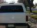 1994 Ford Bronco - This white SUV, possibly a Ford Bronco, is seen from the rear with a camper shell and a Saskatchewan license plate.