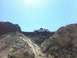 1994 Ford Bronco - A white pickup truck is parked on a ridge with a dirt bike in its bed, under a bright sunny sky.