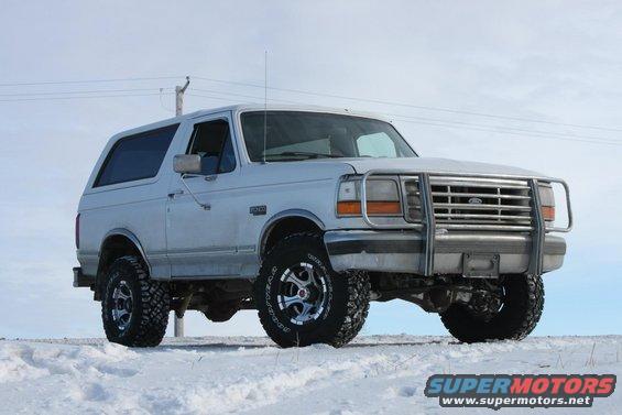 White 1994 Ford Bronco with brush guard in snow