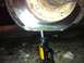 1994 Ford Bronco - A hydraulic jack is holding up a vehicle's brake rotor.