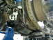 1994 Ford Bronco - Undercarriage view shows a vehicle's brake assembly and suspension, with visible rust and ice.
