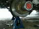 1994 Ford Bronco - Close-up of a vehicle's front wheel hub and brake rotor assembly, supported by blue jack stands in a snowy environment.