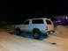 1994 Ford Bronco - White Ford Bronco parked in a snowy driveway at night. The vehicle appears to have a lifted suspension.