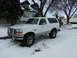 1994 Ford Bronco - A white 1994 Ford Bronco equipped with a brush guard sits in a snowy driveway.