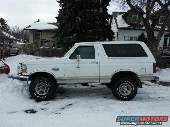 1994 Ford Bronco parked on a snowy street, side view