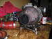 1997 Ford F-250 - Turbocharger assembly sits on a workbench next to red hoses and jars of hardware.