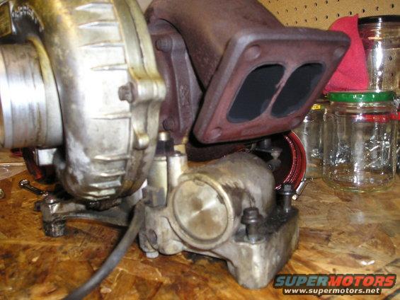 Turbocharger with dual exhaust inlet, on a wooden surface