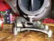 1997 Ford F-250 - A turbocharger assembly sits on a wooden surface, with jars of parts nearby.