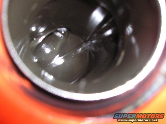 Close-up of dark grease inside a metal container