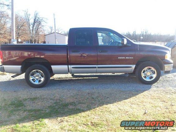 Side view of maroon 2004 Dodge Ram 1500 pickup truck with silver lower body trim