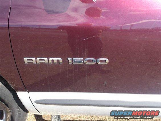 RAM 1500 badge on maroon truck side