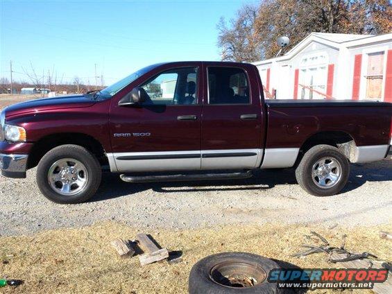 Maroon 2004 Dodge 1500 pickup truck, side view, with silver lower body panels and chrome wheels