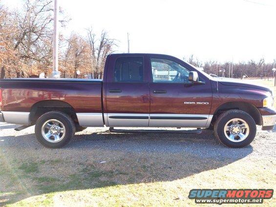 Side view of a purple 2004 Dodge Ram 1500 pickup truck with a silver lower body
