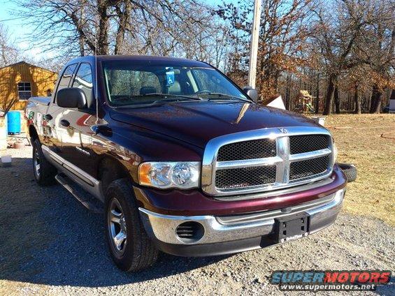 Maroon 2004 Dodge 1500 pickup truck parked outdoors with a gravel driveway