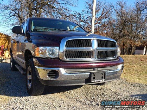 Maroon Dodge Ram pickup truck, front 3/4 view, chrome grille, visible "DriveTime" text on license plate frame