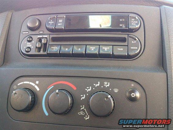 Vehicle's dashboard radio and climate controls with knobs and buttons