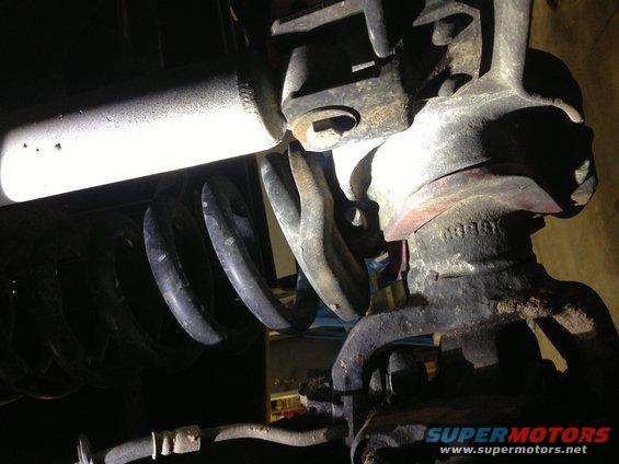 Close-up of rusty suspension parts and coil spring