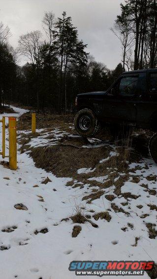 Black 1995 Ford Bronco 3q-front view on snowy, wooded terrain