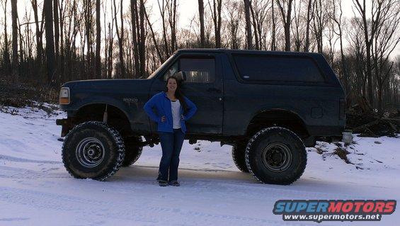 Dark 1995 Ford Bronco with large tires in snow