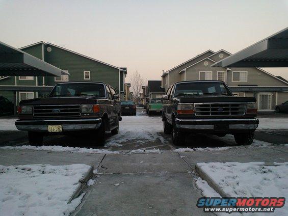 Two 1992 Ford Broncos parked front-facing in a snowy lot