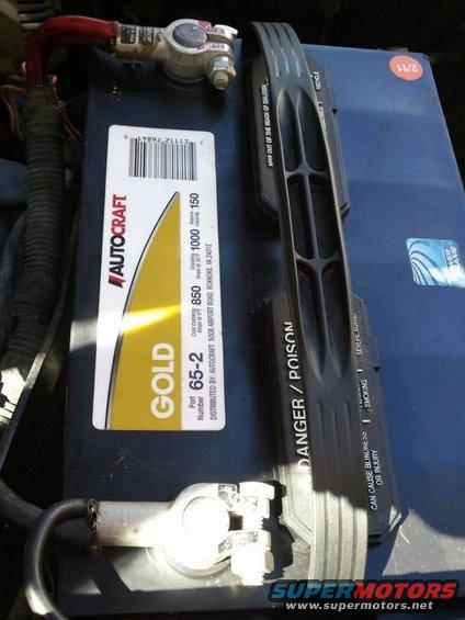 Autocraft Gold car battery with part number 65-2 and danger/poison warnings