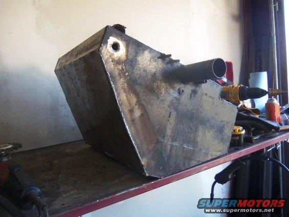 custom metal fuel tank on workbench with drill and tools