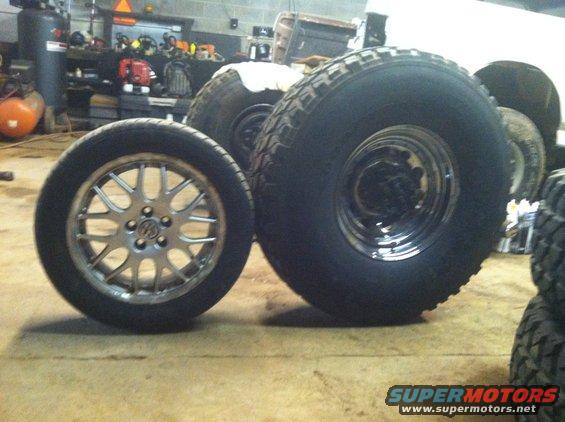 Two tires and wheels, one with a silver multi-spoke rim, the other with a chrome rim