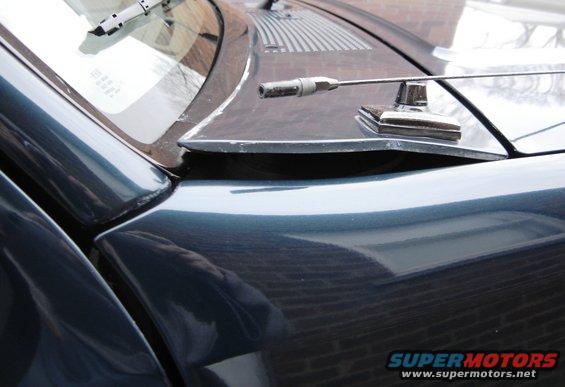 close-up of car hood, windshield, and antenna base