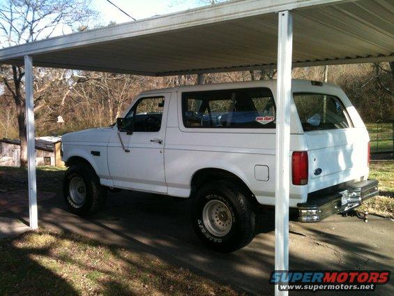White 1992 Ford Bronco parked under a carport, side view