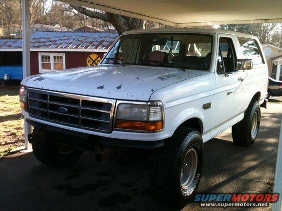 1992 Ford Bronco parked under a carport, front 3/4 view